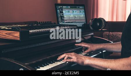 Electronic piano and guitar in room interior. Stock Photo