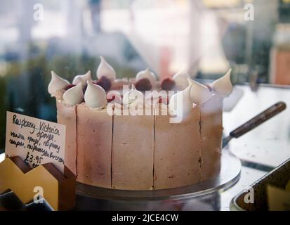 iced vanilla sponge cake (victoria sponge) with meringues and fruit Stock Photo