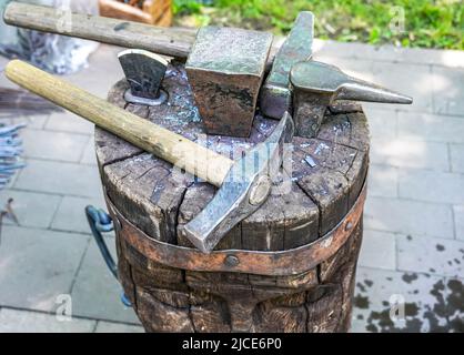 Old rusty blacksmith tools at the outdoors, close up. Blacksmith working space Stock Photo