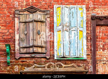 Old building brick wall with an window with hinged shutters. Windows of an old building Stock Photo