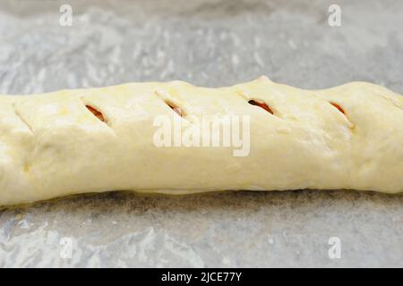 Raw stromboli pizza on papered frying pan horizontal Stock Photo