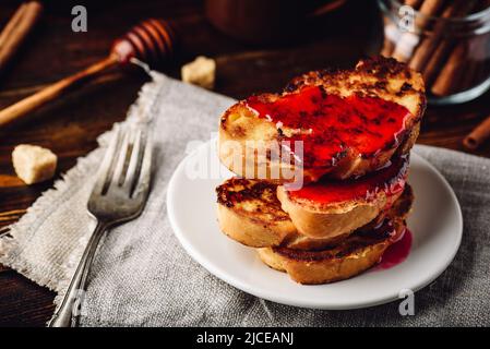 Stack of french toasts with berry marmalade on white plate Stock Photo