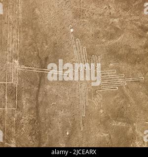 Hummingbird geoglyph sepia colored, Nazca mysterious lines and geoglyphs aerial view, landmark in Peru Stock Photo