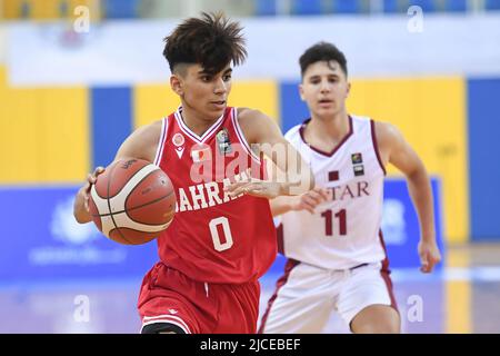 Doha, Qatar. 12th June, 2022. Abdulla Ahmed (L) of Brunei Basketball team in action during the 2022 FIBA U16 Asian Championship match between Brunei and Qatar at Al-Gharafa Sports Multi-Purpose Hall. Final Score; Qatar 85:61 Brunei. Credit: SOPA Images Limited/Alamy Live News Stock Photo