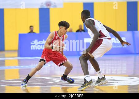 Doha, Qatar. 12th June, 2022. Abdulla Ahmed (L) of Brunei Basketball team and Mohamed Massamba Ndao (R) of Qatar Basketball team in action during the 2022 FIBA U16 Asian Championship match between Brunei and Qatar at Al-Gharafa Sports Multi-Purpose Hall. Final Score; Qatar 85:61 Brunei. Credit: SOPA Images Limited/Alamy Live News Stock Photo