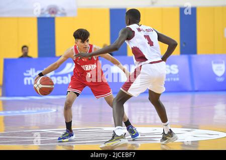 Doha, Qatar. 12th June, 2022. Abdulla Ahmed (L) of Brunei Basketball team and Mohamed Massamba Ndao (R) of Qatar Basketball team in action during the 2022 FIBA U16 Asian Championship match between Brunei and Qatar at Al-Gharafa Sports Multi-Purpose Hall. Final Score; Qatar 85:61 Brunei. Credit: SOPA Images Limited/Alamy Live News Stock Photo