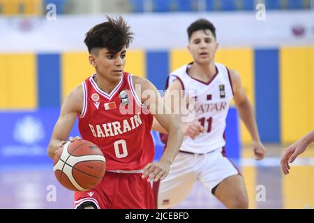 Doha, Qatar. 12th June, 2022. Abdulla Ahmed (L) of Brunei Basketball team in action during the 2022 FIBA U16 Asian Championship match between Brunei and Qatar at Al-Gharafa Sports Multi-Purpose Hall. Final Score; Qatar 85:61 Brunei. Credit: SOPA Images Limited/Alamy Live News Stock Photo