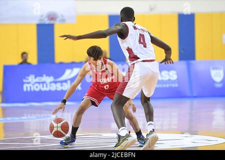 Doha, Qatar. 12th June, 2022. Abdulla Ahmed (L) of Brunei Basketball team and Mohamed Massamba Ndao (R) of Qatar Basketball team in action during the 2022 FIBA U16 Asian Championship match between Brunei and Qatar at Al-Gharafa Sports Multi-Purpose Hall. Final Score; Qatar 85:61 Brunei. Credit: SOPA Images Limited/Alamy Live News Stock Photo