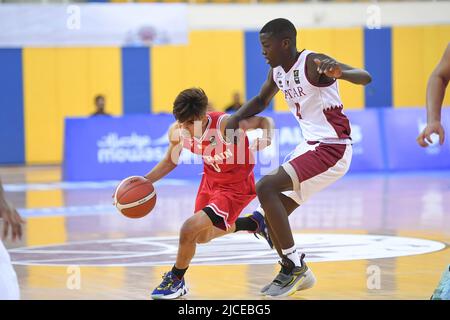 Doha, Qatar. 12th June, 2022. Abdulla Ahmed (L) of Brunei Basketball team and Mohamed Massamba Ndao (R) of Qatar Basketball team in action during the 2022 FIBA U16 Asian Championship match between Brunei and Qatar at Al-Gharafa Sports Multi-Purpose Hall. Final Score; Qatar 85:61 Brunei. Credit: SOPA Images Limited/Alamy Live News Stock Photo