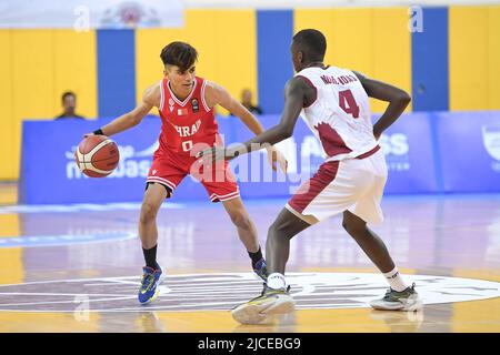 Doha, Qatar. 12th June, 2022. Abdulla Ahmed (L) of Brunei Basketball team and Mohamed Massamba Ndao (R) of Qatar Basketball team in action during the 2022 FIBA U16 Asian Championship match between Brunei and Qatar at Al-Gharafa Sports Multi-Purpose Hall. Final Score; Qatar 85:61 Brunei. Credit: SOPA Images Limited/Alamy Live News Stock Photo