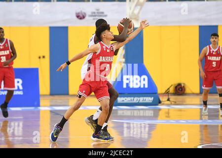 Doha, Qatar. 12th June, 2022. Abdulla Ahmed (L) of Brunei Basketball team and Mohamed Massamba Ndao (R) of Qatar Basketball team in action during the 2022 FIBA U16 Asian Championship match between Brunei and Qatar at Al-Gharafa Sports Multi-Purpose Hall. Final Score; Qatar 85:61 Brunei. (Photo by Luis Veniegra/SOPA Images/Sipa USA) Credit: Sipa USA/Alamy Live News Stock Photo