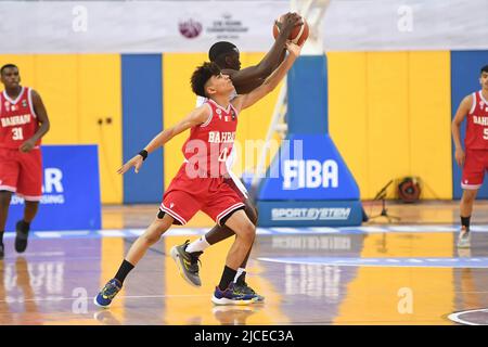 Doha, Qatar. 12th June, 2022. Abdulla Ahmed (L) of Brunei Basketball team and Mohamed Massamba Ndao (R) of Qatar Basketball team in action during the 2022 FIBA U16 Asian Championship match between Brunei and Qatar at Al-Gharafa Sports Multi-Purpose Hall. Final Score; Qatar 85:61 Brunei. (Photo by Luis Veniegra/SOPA Images/Sipa USA) Credit: Sipa USA/Alamy Live News Stock Photo