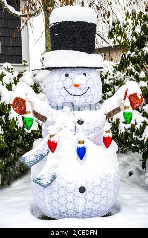 blow up snowman decoration in front of a home at Christmas time Stock Photo