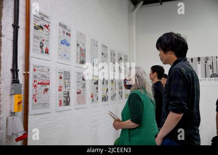 London, UK. 12th June, 2022. Visitors are seen at the exhibition relating to the Hong Kong pro-democracy movement. 'Bricks on the Road' is an exhibition in London displaying video footage, photos and artworks from the Hong Kong pro-democracy movement. Credit: SOPA Images Limited/Alamy Live News Stock Photo