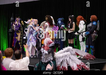 Melbourne, Australia. 12th June, 2022. Cosplayers take part in a cosplay competition to show off their creation at OzComicCon 2022. OzComicCon saw thousands of pop culture fans descend on the Melbourne Exhibition Centre for the weekend to enjoy forums, cosplay competitions, and celebrity guess. The first day of the event was a sell out with people returning on mass to the convention after postponed and cancelled events under COVID lockdowns. Credit: SOPA Images Limited/Alamy Live News Stock Photo