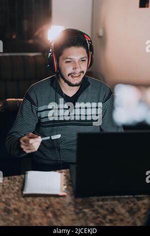 Freelancer working from home and talking to clients over the Internet Stock Photo