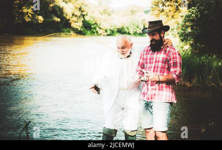 Mature man with friend fishing. It is not sport, it is obsession. Bearded  men catching fish. Summer vacation. Fisherman with fishing rod. Activity  and Stock Photo - Alamy