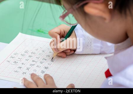 HOHHOT, CHINA - JUNE 13, 2022 - Students from Hengchang Dianxiang Primary School take part in a Chinese writing contest in Yuquan district of Hohhot, Stock Photo