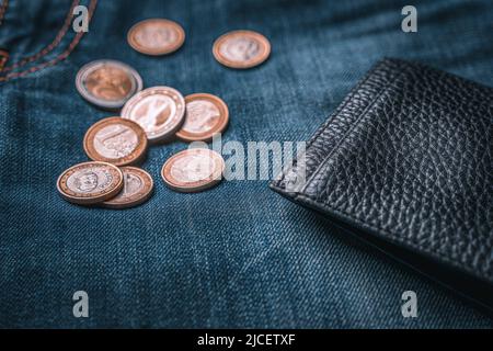 Empty black leather wallet and euro coins on jeans, close up Stock Photo