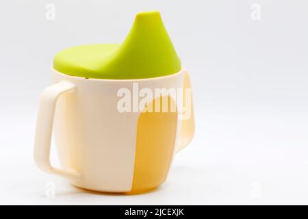 a used baby mug on a light background Stock Photo