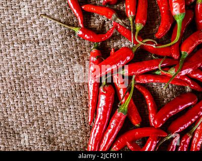 Fresh red chili peppers on vintage cloth background. fresh Red chilli isolated. Stock Photo