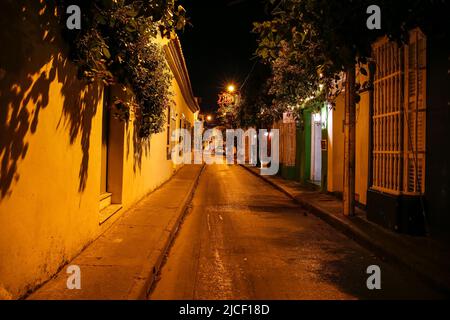 Iluminated empty street at night with colonial buildings in Cartagena, Unesco World Heritage Stock Photo