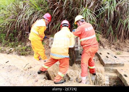 LIUZHOU, CHINA - JUNE 13, 2022 - Highway emergency repair workers clear mudslides on the Sanliu Expressway in Liuzhou city, South China's Guangxi Zhua Stock Photo