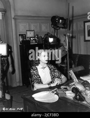 RITA HAYWORTH on set candid during filming of AFFAIR IN TRINIDAD 1952 director VINCENT SHERMAN story Virginia Van Upp and Bernie Giler gowns Jean Louis cinematographer Joseph Walker producers Rita Hayworth and Vincent Sherman The Beckworth Corporation / Columbia Pictures Stock Photo