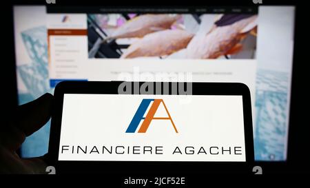 Person holding cellphone with logo of US retail company Neiman Marcus Group  Inc. on screen in front of business webpage. Focus on phone display Stock  Photo - Alamy