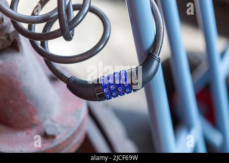 Essen, Germany - Mar 26, 2022: Close up of a locked four-digit combination lock for bicycles. Stock Photo