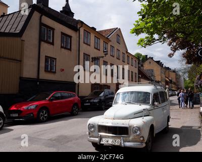 Old Volvo in front of an old row of houses Stock Photo