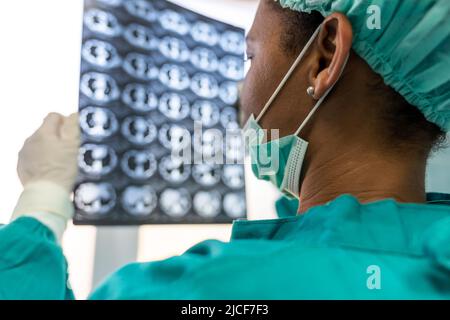 Female medical doctor looking at x-rays in a hospital. Healthcare surgery diagnosis concept Stock Photo