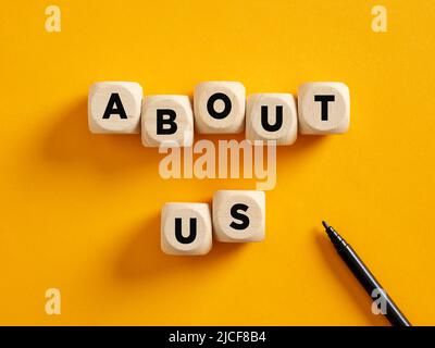 The word about us on wooden cubes. Business communication and information concept. Stock Photo
