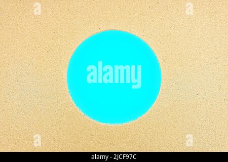 Round frame made from sand on blue. Summer pool vacation background. Stock Photo