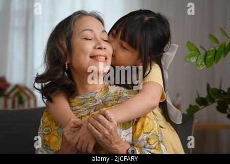 Happy moments of lovely little girl embracing her grandmother. Multi generational, family, gratitude, love concept Stock Photo