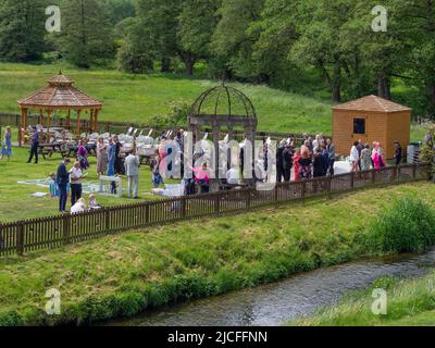 Wedding guests at an outdoor reception on a sunny day, Weeford, Staffordshire, UK Stock Photo