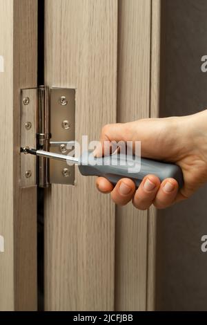Carpenter installs a door hinge. Stock Photo