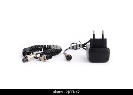 Mains charger or power bank and spiral cable for body camera isolated on white background with shadow. Closeup, side view. Stock Photo