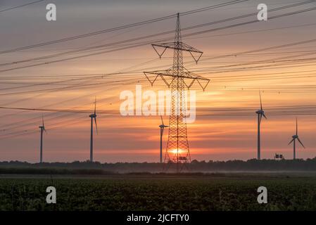 Sunrise, wind turbines, power pole, Irxleben, Saxony-Anhalt, Germany Stock Photo
