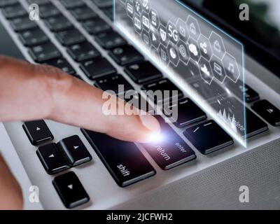Close up hand man touch enter on laptop keyboard with hologram screen connect social media and social network 5G. Technology lifestyle concept. Man ha Stock Photo