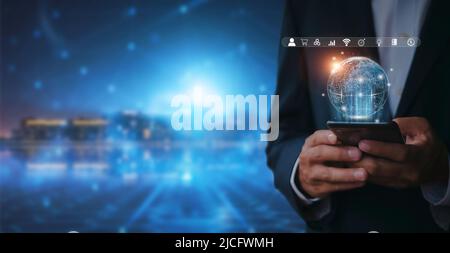 Hand of businessman holding mobilephone with global internet connection application technology and digital marketing, Financial and banking, Digital l Stock Photo