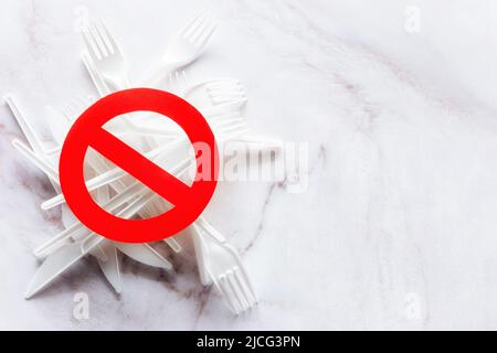 prohibition sign on disposable plastic tableware with place for text on marble background Stock Photo
