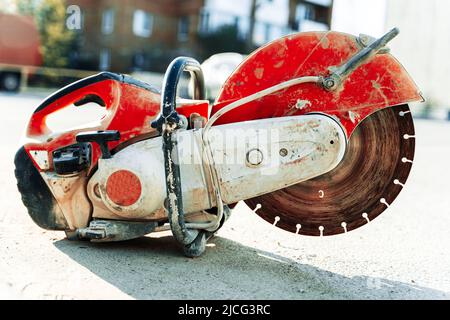 a gasoline cutting machine with a disc for cutting concrete Stock Photo