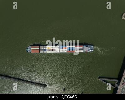 Heavy transport container bulk carrier freighter overhead top down view on sea lake open water isolated. Commercial maritime sea shipping. Stock Photo