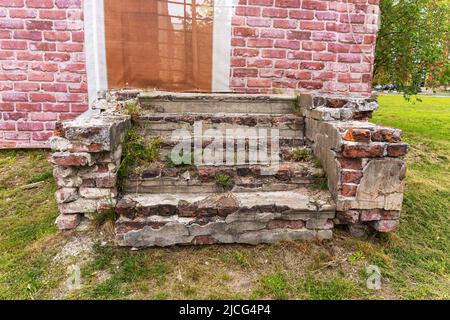 old ruined brick porch of the house and the steps of the old mansion Stock Photo