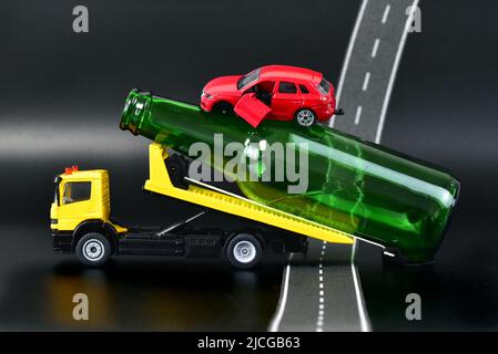 tow Truck transporting toy car with accident drunk car driver Stock Photo