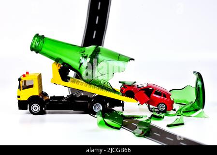 tow Truck transporting toy car with accident drunk car driver Stock Photo