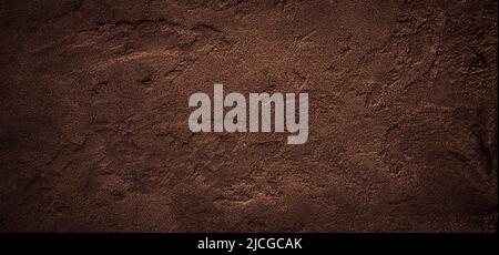 Dark chokolate brown sugar-like grainy texture background Stock Photo