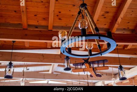 Beautiful hanging lamps and a wooden plane Stock Photo
