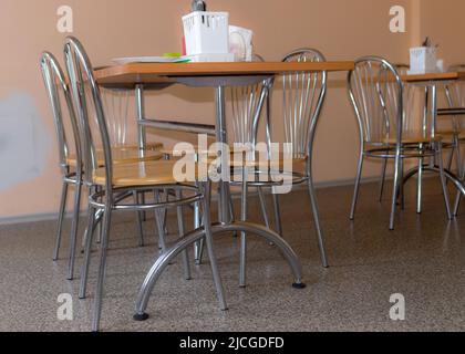 school kitchen canteen, metal table and chair legs, canteen equipment, catering establishment, tables and chairs Stock Photo